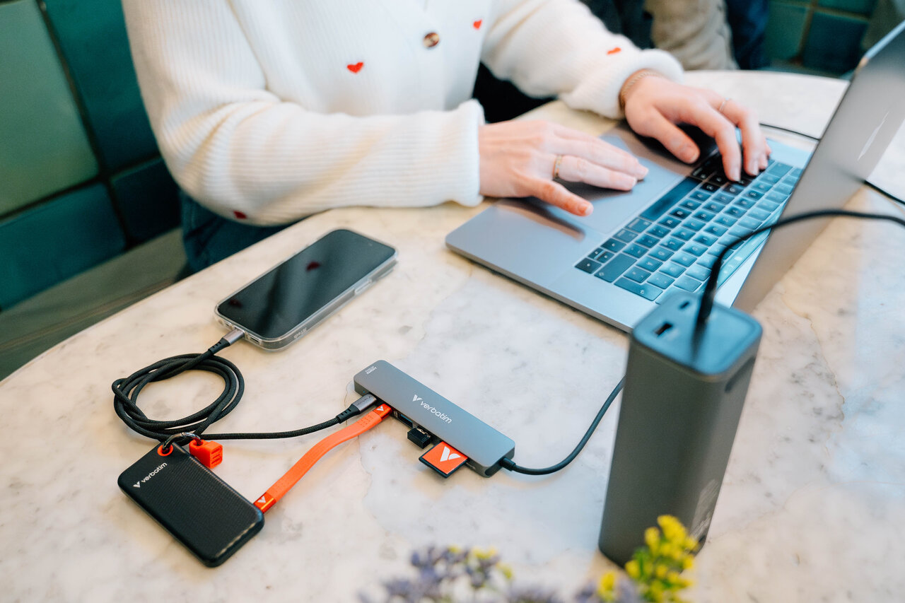 USB hub plugged into a laptop, charger, SSD and charging an iphone